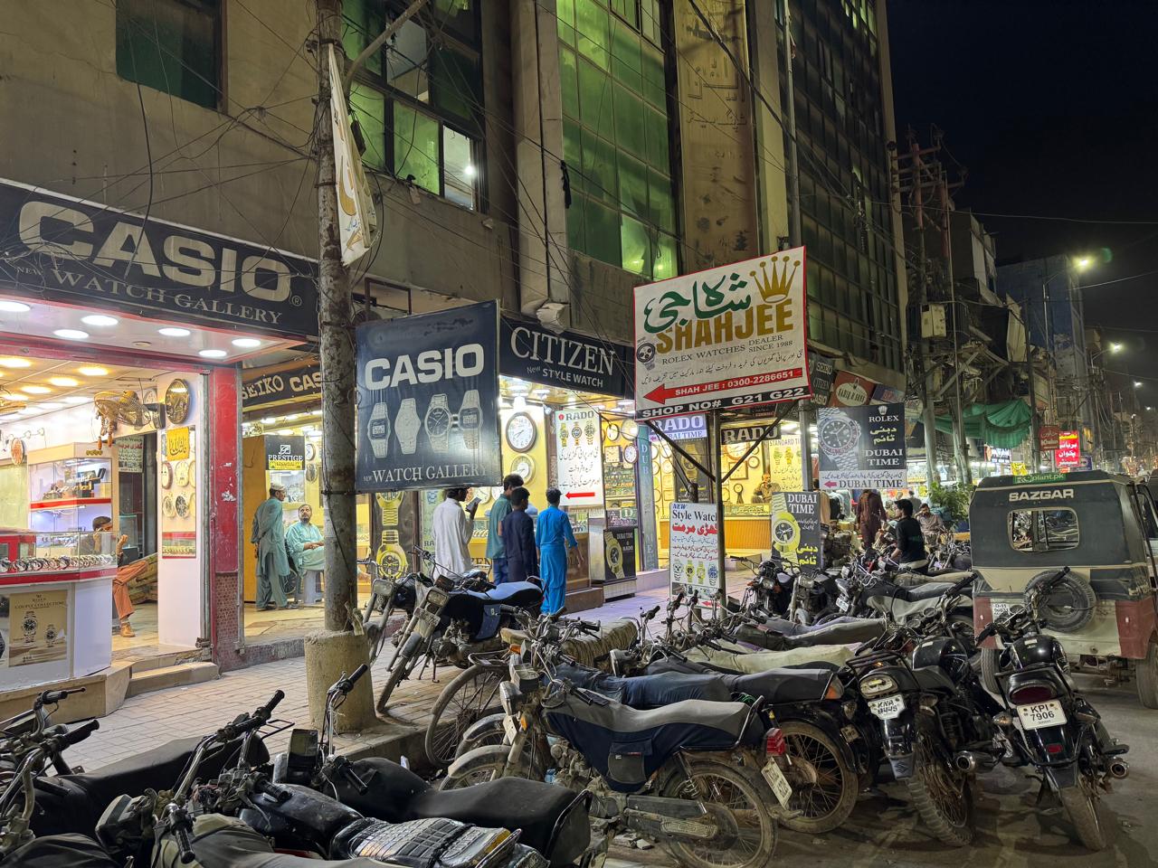 Shahjee Rolex Dealer signboard at night — Zaib-an-Nissa Street Saddar Karachi